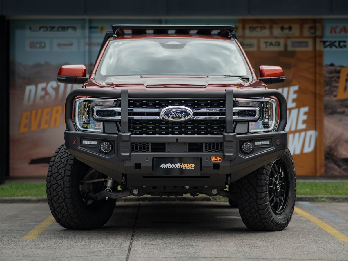 A 4WD ute set up for towing with a bull bar and roof rack